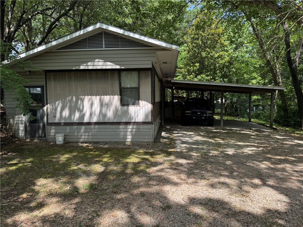 2.62 Acres on Bethel Blacktop Rd! Older 1,036 SF mobile, 3 BR, 2 BA with detached 26x40 shop. First time on the market. There is a live creek at the bottom of the hill. Family would consider leaving most of the contents with the right offer. Large covered porch. Family has not lived there, so there is no property disclosure. Being sold AS-IS.