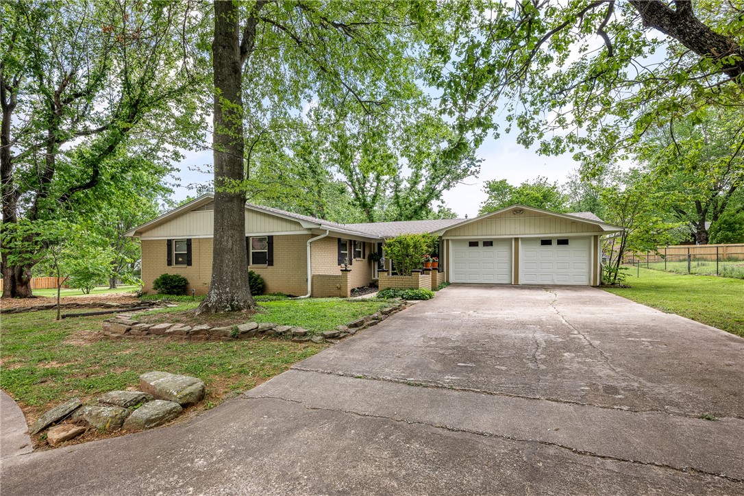 Beautiful one-level, 3 bedroom, 2 bath single family home in East Fayetteville. Updated kitchen features gorgeous granite countertops, stainless steel appliances, gas range & refrigerator. A comfortable floor plan w/hardwood floor & tile throughout is both attractive & easy to maintain. The home offers 2 living areas, providing warm & relaxing spaces to unwind, includes wood-burning fireplace & built-in desk. Good-sized bdrms each incl ceiling fans. Primary bath has a walk-in shower & both baths incl pedestal-style sinks for added elegance. Built-in storage closets provide ample storage. Washer/dryer stays. Oversized 2-car garage features lots of built-in storage & dog door access to fenced backyard. Enjoy large mature trees, a .48-acre lot, covered back patio & spacious deck, offering great outdoor space for relaxing/entertaining. Tucked away in a cul-de-sac near Gulley Park, bike trails, shopping, dining & Fayetteville favorites. Available August 1st. Sec Dspt $2,195, Clng Fee $375, Pet Fee $300 each/annually.