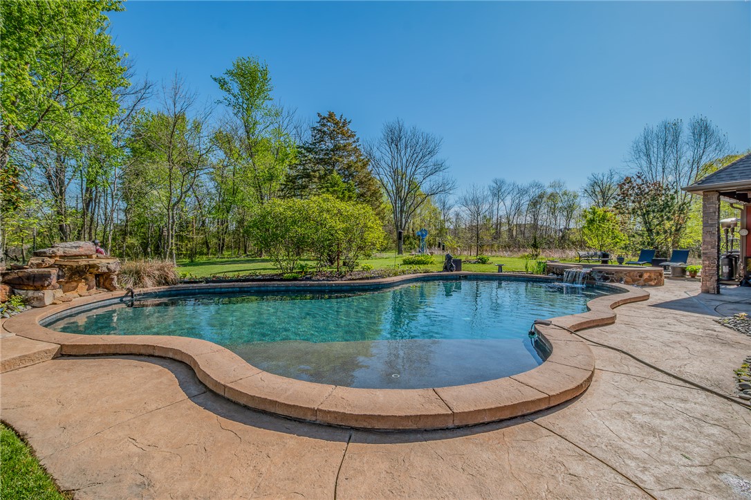 Also includes 1804 SW Palmer Creek...Don’t miss the opportunity to own this unique & versatile property offering 6.77 acres w/private drive & park like setting in town. Stunning primary residence w/resort style gunite, salt water pool AND a 3,600 SF heated & cooled Shop/Warehouse building w/office space. Primary residence w/4 BRS & spacious floor plan flanked w/rich wood beams & stone accents throughout. Chef’s kitchen boasts double ovens & sinks, oversized island & walk in pantry. Owner’s suite w/ FP & spa like bath featuring walk around closet. Designed for outdoor entertaining w/expansive patio/deck areas, kitchen, pool w/tanning shelf & waterfall features & pool bath surrounded by natural beauty. Shop/Warehouse is complete w/3 offices, full kitchen plus Shop area w/3 overhead doors & additional bath. The opportunities are endless.