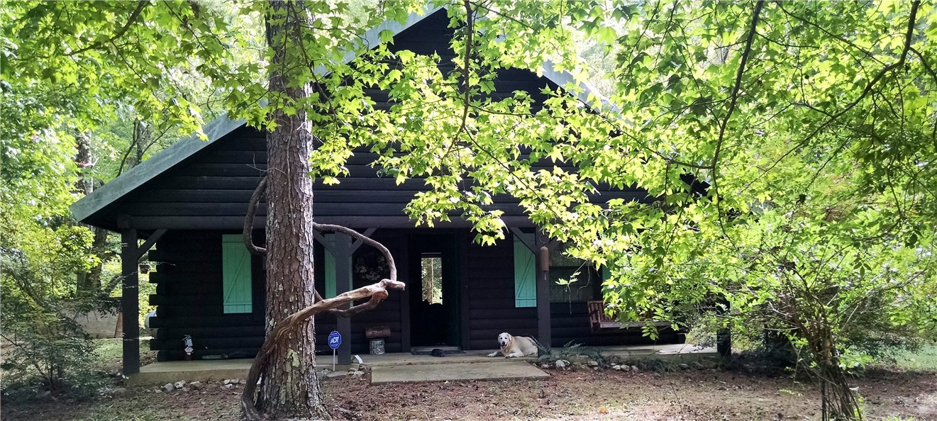 Satterwhite Log Home sitting at the edge of Brushy Creek just below Dog Mountain in middle of Ouachita National Forest. Open floor plan w/ 2 loft bdrm areas separated by a catwalk. 3rd bedroom located in back of cabin w/ "roll up" windows overlooking creek. 6x30 covered front porch,12x30 rock patio, 12x30 covered/treated wood deck over creek w/ elect./fans. Elect. is furnished by 540KW/580HP Mitsubishi generator/300 gallon diesel tank. Centrally located between Mena, Potter Junction, and Hatfield, Ar.