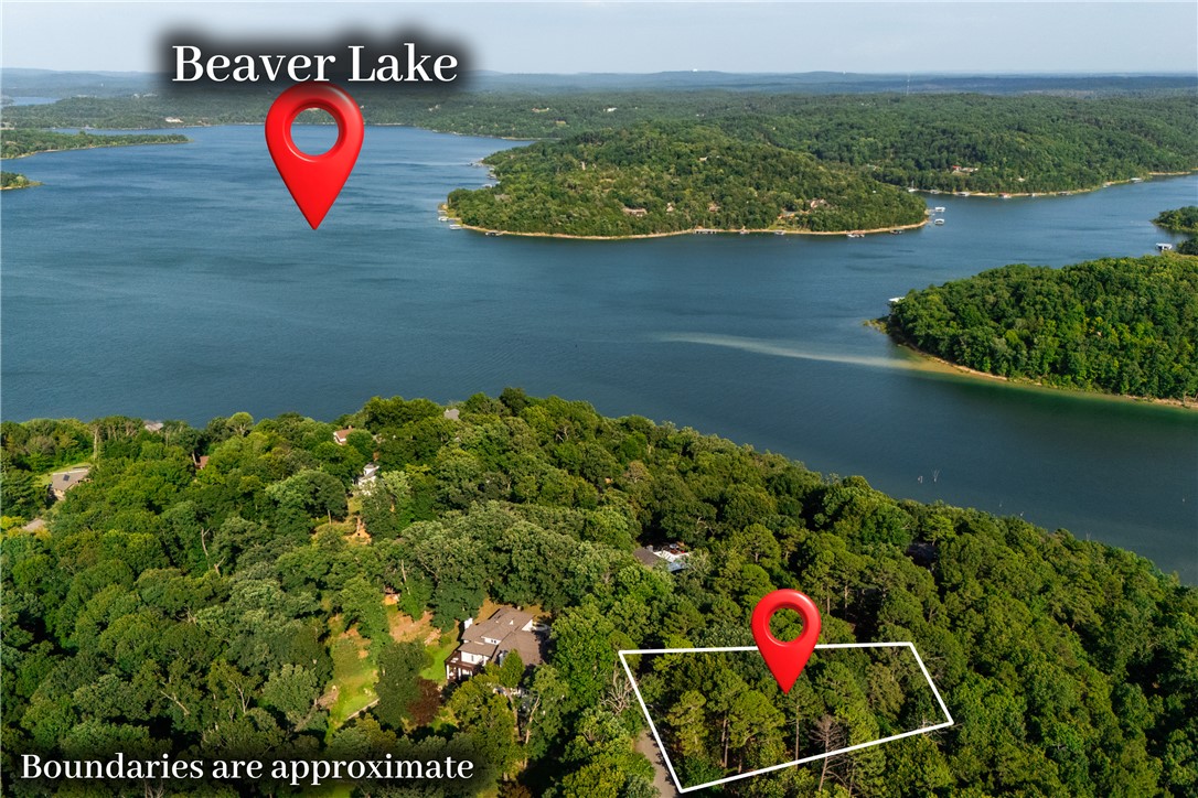 Beautiful 0.63-acre lot in the established Runnymede Subdivision, just minutes from Beaver Lake! With generous road frontage, a fairly level front section, and a sloped rear, this property offers an excellent opportunity to build a custom home with the potential for a walkout basement. Utilities are available at the road, and the neighborhood features a peaceful walking trail. Enjoy being just 2 minutes from the Beaver Lake public boat ramp, 5 minutes from Prairie Creek Marina, and only 10 minutes from historic downtown Rogers, giving you easy access to boating, dining, shopping, and entertainment. The previous owners had the lot approved for a septic system for a custom home with a walkout basement