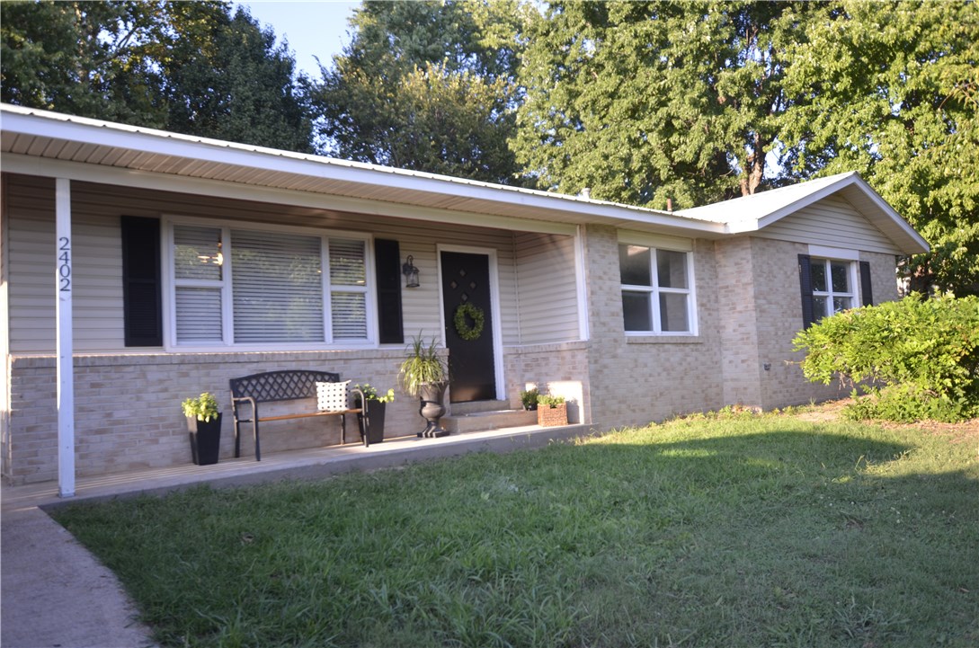 OPEN HOUSE Sunday, 9/11 1-4!  Sparkling diamond! Fabulously remodeled home on oversized lot close to shopping, restaurants, I-49 & only .5 mile from Clear Creek Trail. Incredibly modern finishes & colors. Everything new: flooring (super nice wood laminate, tile, carpet), lighting/plumbing fixtures, SS appliances. 1,340 SF, 3 bedroom, 1.5 bath, huge living room, huge kitchen w/granite island & concrete countertop open to huge dining, laundry/mud room. Newer vinyl windows/siding, metal roof. You'll love!
