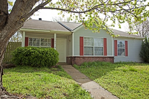 New Flooring, New Paint cathedral ceilings and a cozy fireplace in the Living room 3 bedrooms and 2 full bathe and a fenced in back yard.  Garage loads from the back of the home.