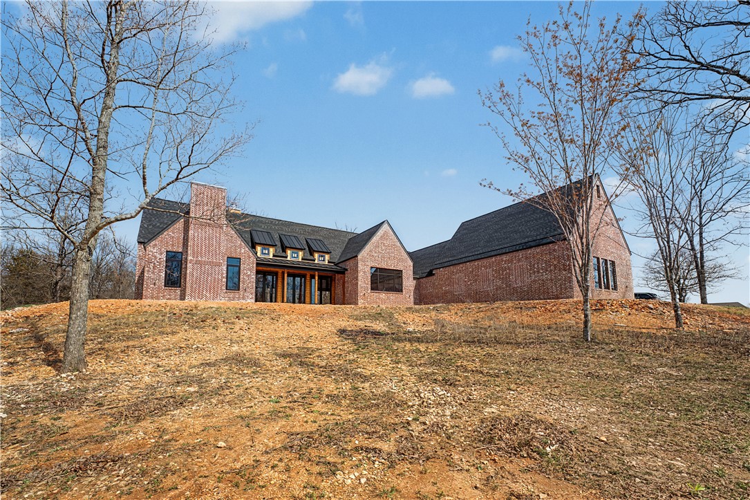 This amazing property boasts wonderful views and a pastoral setting in Pepper Hills Estates. Located close to Siloam Springs and only a short drive to XNA airport. Special features that set this home apart
include wood beams in vaulted ceilings, high-quality wood floors, spectacular NanaWall that opens to rear covered patio, specialty kitchen with adjoining butler’s pantry and so much more!