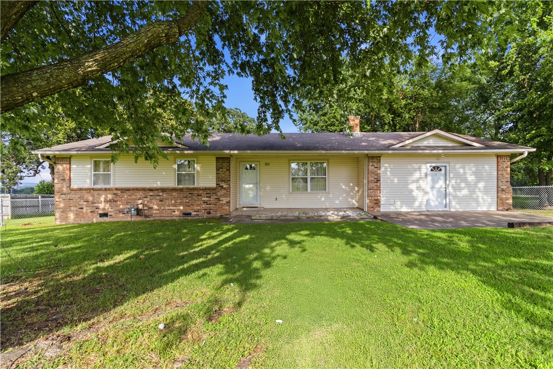 Looking for room to breathe without sacrificing convenience? Situated on 1.39 level acres in the heart of town, this charming 3-bedroom, 2-bath home offers the space you've been searching for inside and out. The garage has been thoughtfully converted into a second living area of over 500 square feet, providing endless possibilities for a game room, media room, home office or hobby space.
Step outside and enjoy the expansive yard with plenty of room for gardening, outdoor entertaining, pets, play, or whatever hobbies you can imagine. Mature trees and open green space create a peaceful setting that's hard to find this close to town. Conveniently located with quick access to Hwy 62, making commutes to Farmington, Fayetteville, Licoln and even Oklahoma a breeze. This home offers a warm, welcoming feel the moment you walk through the door. If you're tired of cookie-cutter neighborhoods and tiny lots, this is your opportunity to own a property with character, space, and endless potential. Property selling "as is" .