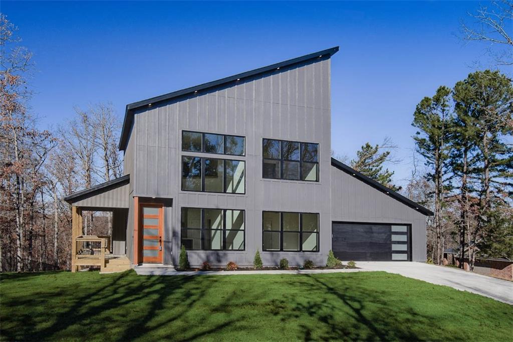 MOVE-IN READY! This modern newer construction home sits on a flat .35 acre wooded lot! Located down the street from the Lake Loch Lomond boat launch! Only minutes to Highalnds Golf Course, Branchwood Recreation Center, and I-49! This stunning home showcases modern high-end finishes throughout! 2BD's + office. Step inside to discover beautiful floor-to-ceiling custom cabinets and a huge waterfall island, perfect for entertaining family and friends. The kitchen is also equipped with sleek black stainless steel appliances, including a gas range. No carpet! Breathtaking two-story living room with huge windows going up to the ceiling! Retreat to the primary suite with high ceilings and a stunning walk-in tile shower that elevates your everyday routine. Guest bedroom is located on the main level.