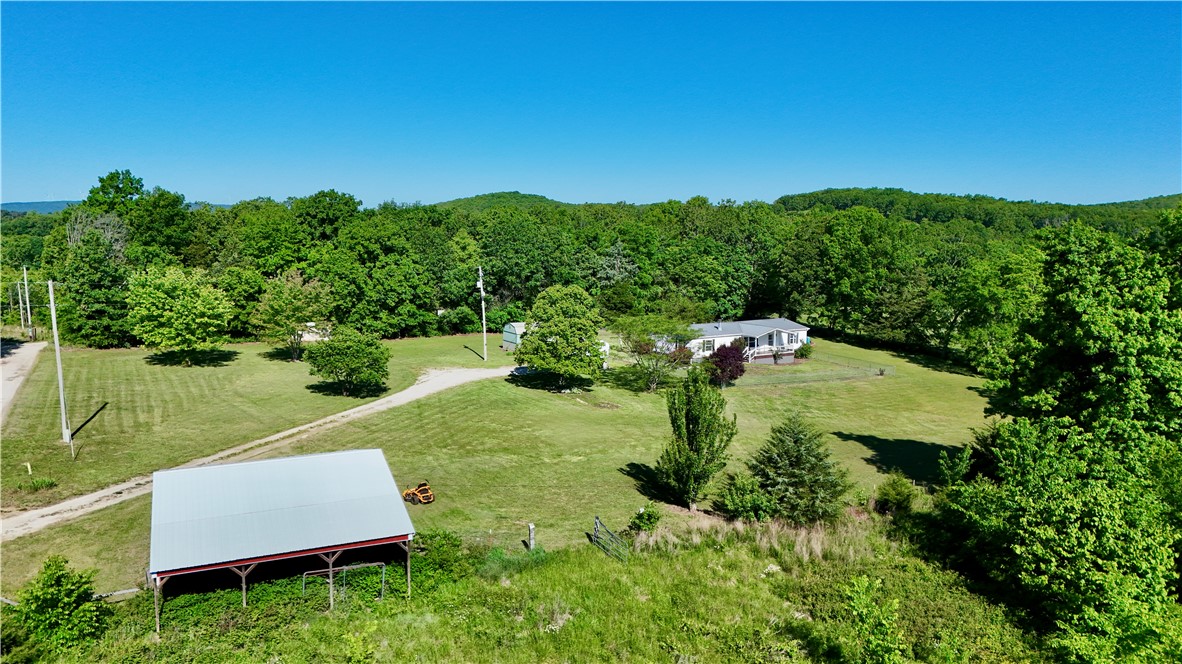 Escape to the peace and beauty of county living on this gorgeous 5 acre property, just a short drive from town! Nestled in a serene and picturesque setting, this well-maintained property offers the  perfect blend of privacy and convenience. The 3-bedroom, 2-bath 1994 manufactured home features a welcoming covered front porch-perfect for enjoying your morning coffee- and a spacious back deck ideal for entertaining or relaxing while taking in the surrounding nature.
The land itself is truly special, with a beautiful setting that attracts abundant wildlife, making it a nature lover's dream. A very nice barn and additional outbuilding provide plenty of space for storage, hobbies, or livestock. 
Whether you are looking for a peaceful retreat, hobby farm potential, or just room to breathe, this property offers it all. Being sold "as is".