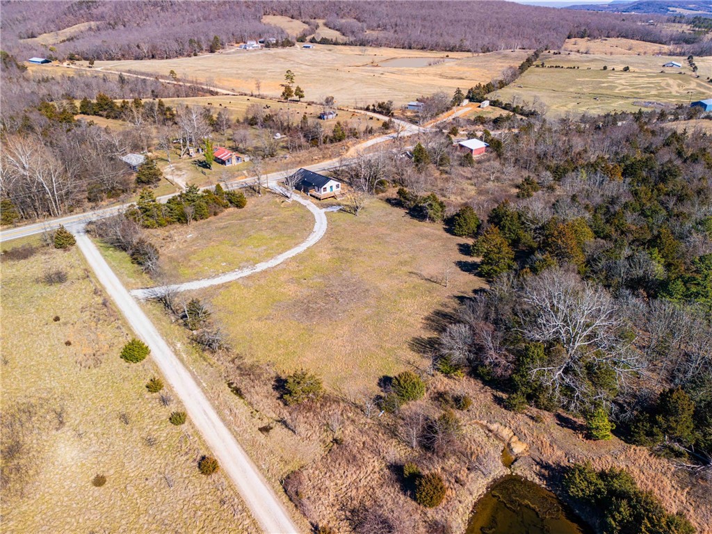 Once the historic Alco General Store, this one-of-a-kind property has been thoughtfully transformed into a 3-bedroom, 2-bath home on 3+ acres, blending preserved character with modern updates throughout. Original details honor the building’s past, while today’s comforts make it ideal for everyday living.

Inside, thick 13-inch walls showcase the solid craftsmanship of its original construction. Timeless subway tile accents pair beautifully with quartz countertops, while a full butler’s pantry offers exceptional storage and functionality.

The primary suite provides a relaxing retreat with a soaker tub and subway tile walk-in shower featuring double shower heads for a spa-like experience. A hidden bookcase adds a fun, distinctive touch and nod to the property’s rich history.

Set on 3+ peaceful acres, this property offers a rare opportunity to own a beautifully restored piece of local heritage.