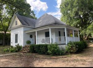 Love historic homes? Check out this 100+ year old,  southern beauty. Recently renovated and move in ready! 1690 sq. foot, 4 large bedrooms, 2 bath with 12 ft. ceilings. Central air & gas heat with Blackhills. Newer energy efficient windows all around. Perfect to host your next family gatherings. Home offers large eat in kitchen and also a formal dining room. Sit and enjoy your morning coffee on the spacious wrap around porch. Newer storage shed conveys. Shaded lot with fenced backyard. Home is within walking distance to Eastside City Park, fishing, and river access. Close to downtown shopping and amenities.