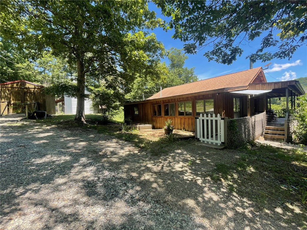 Welcome home to your Ozark oasis on the beautiful George’s Creek! This property boasts 10.56 unrestricted acres m/l, a mix of pasture and wooded areas. The home overlooks George’s Creek with beautiful views of abundant wildlife. This two bedroom one bath home has 1588 sf,custom tongue and groove wood walls and beautiful pine floors. There is a 20 x 30 shop building with concrete floor, 3 storage sheds, and alsoa she-shed ready for your imagination!