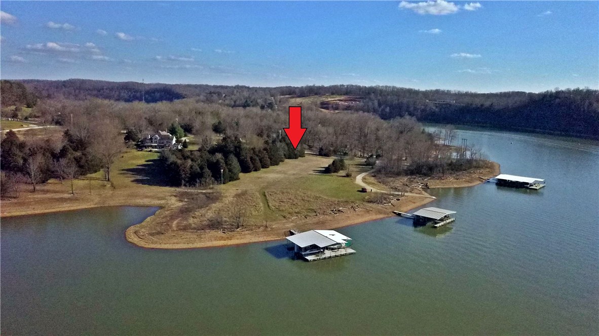 Looking to build your dream lake home? This 2.34(+/-) acre lot is lake front and level. Situated on the tip of the peninsula, you are in for some amazing lake views. Less than 100 yards from your slip in a community boat dock as well as a boat launch ramp. This gem won't last long.