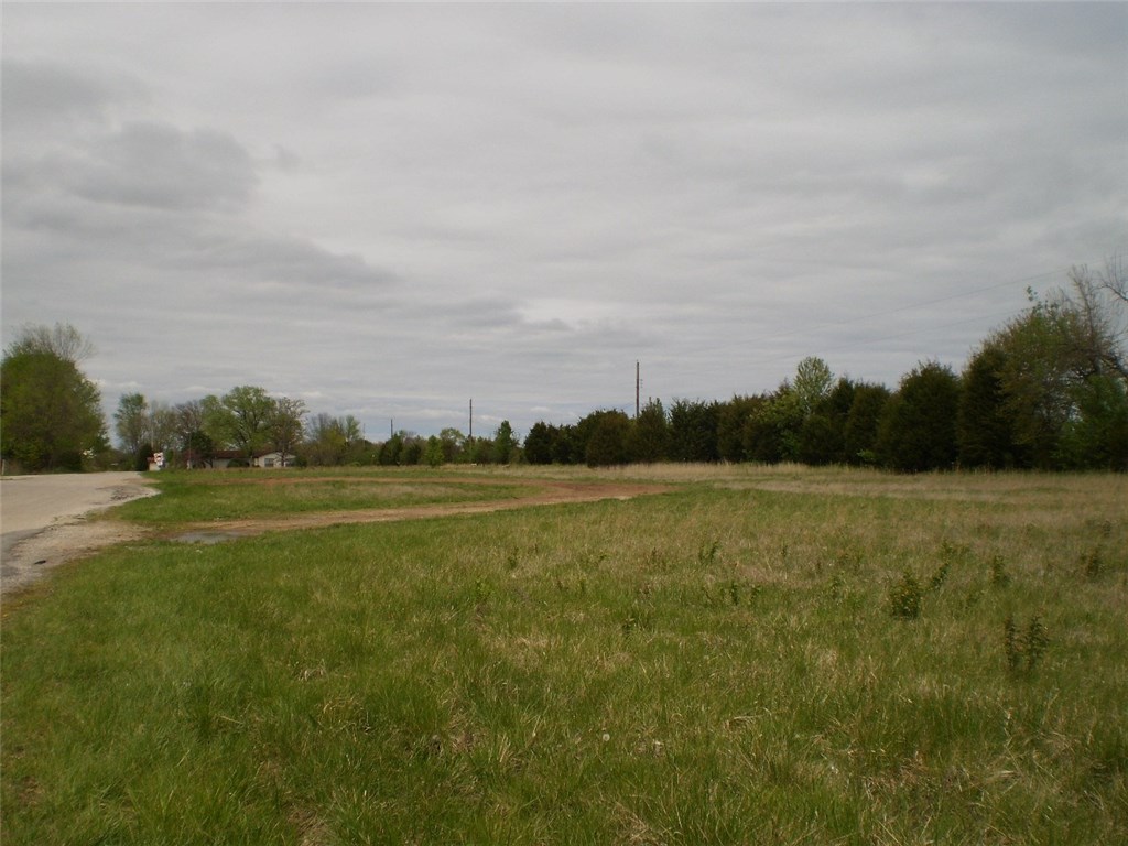 9.95 Acres of great commercial land in the corner of 8th and Hudson. Great opportunity for a variety of businesses, close to NWACC, Sams Club, Bekaert Manufacturing and strubbing.  This is a very hot corner, high traffic count.