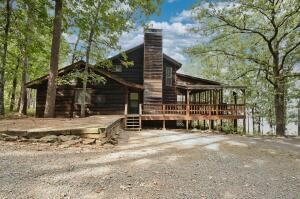 **Home is under contract, but can still be shown for backup offers** Lake House on Greers Ferry! Enjoy country seclusion and one of the finest lakes in the natural state with this quaint lake cabin. This property features lake frontage, a new community boat dock with private boat slip, serene screened in porch, large parking surface, and it's located on a dead end road that is only a 2.1 mile drive from the Mill Creek Campsite boat ramp.Home is approximately 2076 square feet and has 3 bedrooms, 2 bathrooms and has an open concept kitchen/dining/living space, utility room, screened and un-screened porches, and a large loft that a great flexible space. Roof and hvac replaced within the last 2 years. Check out the 3D tour and call your agent today.