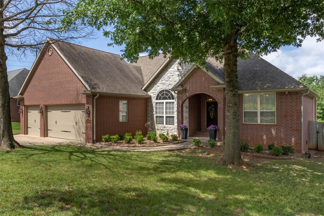 Experience refined living in this beautifully appointed 4-bedroom, 3-bath home with a bonus room/office in the desirable Bridgeport Subdivision. Designed for both comfort and elegance, the open-concept layout features a spacious living area centered around a gas log fireplace and an oversized eat-in kitchen, perfect for entertaining and everyday living. A private upstairs primary suite offers exceptional flexibility for guests or multi-generational living. The luxurious main-level owner's suite boasts dual vanities, dual walk-in closets, a separate shower, and a relaxing, jetted tub. Step outside to a covered patio overlooking an expansive, private backyard with ample room for a custom pool and your dream outdoor oasis. However, residents do enjoy access to the community's zero-entry swimming pool. Ideally located in West Fayetteville with quick access to I-49 and just minutes from premier shopping, dining, and top-rated schools. Buyers may receive up to $5,000 toward closing costs when using the preferred lender.