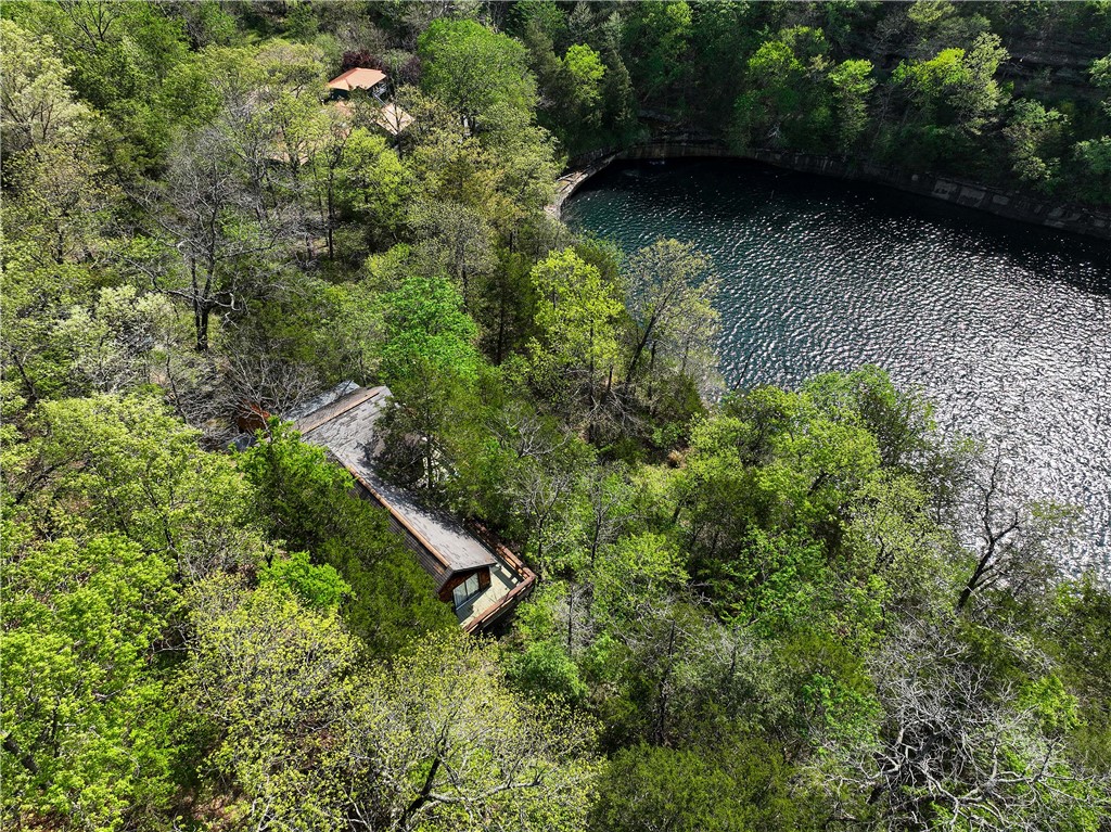 Waterfront Cabin in Private Waterfall Cove on Beaver Lake w/ 3.17 Acres, Dock Slip Available & Rare Future Opportunity! Tucked inside a privately held cove on Beaver Lake, this 3.33-acre property offers a setting that simply cannot be recreated. A year-round waterfall flows into the cove below, creating a peaceful, meditative atmosphere you’ll feel the moment you arrive. The 1-bedroom, 1-bath cabin—crafted by local artisans—is perfectly positioned to take in the view, with over 900 sqft of elevated decking overlooking the waterfall and water’s edge. With multiple potential building sites, the acreage offers the flexibility to expand, create a private compound, or hold as a long-term asset. .25 mile away, is a dedicated boat slip is available. With a first right of refusal on the remaining portions of this privately held cove—featuring additional acreage, a residence, and 2-slip boat dock—offering a rare opportunity to expand ownership over time in one of Beaver Lake’s most gorgeous settings.