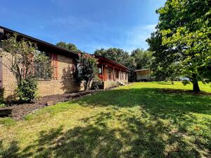 NOW OFFERING A 12 MONTH HOME WARRANTY AND A NEW PRICE! Come enjoy this SPACIOUS, 4 BEDROOM, HILL-TOP home on an ACRE! You'll feel right at home with the wood burning fireplace, the ample space, and the vaulted ceilings. Your roomy kitchen can accommodate a little breakfast nook while still allowing plenty of space for that beautiful dining table in your separate dining room. Looking to add a game room or a second living area? Don't look any further. The downstairs area offers you 1,446 Sq. Feet to make your own with a SECOND fireplace! This amazing property also comes with an attached 2 car garage with sliding shelves to accommodate a 2nd laundry area just in case the one in the downstairs area isn't cutting it! Additionally you'll have access to your very own RV carport/ Shop!