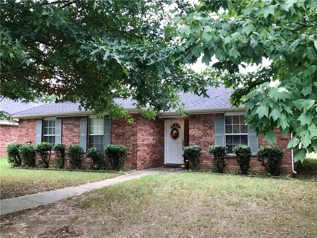 HOT! HOT! HOT!  Schedule your showing for this 1300 ft. beauty in Heritage Village, because it won’t last long!  This house boasts an ALL-BRICK exterior and newer roof to ease your maintenance worries.  New paint and new LUXURY VINYL PLANK flooring continuous throughout makes this great floorplan flow perfectly.  Large living area with gas log fireplace and an extra room on the front that could be used as formal dining, an office, or even an extra living/TV area.   Two-car garage with rear-entry from a paved alley, and convenient to the U of A as well as shopping and medical.  This home would make a great rental income for investors, too.  Don’t miss out.