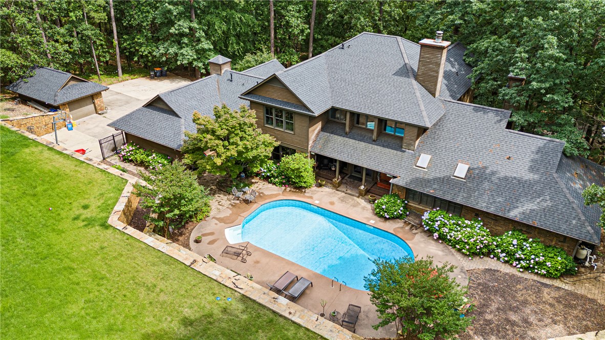 Welcome to your dream home! This stunning 5,310 sq ft home offers a grand layout; 4 spacious bedrooms & 4.5 beautiful bathrooms. The extra-large master suite boasts a cozy fireplace and spa-like bath. At the heart of the home is a gourmet kitchen designed for both everyday living and entertaining, complete with high-end finishes and prep space. The large game room is currently used as a fifth bedroom, offering ultimate flexibility for your lifestyle.

Step outside to your own private paradise—this home sits on a secluded wooded lot with a large outdoor entertaining space; perfect for grilling, cooking, and making memories. Dive into your in-ground pool with a diving board or unwind under the stars in your own serene backyard escape.

Additional highlights include a 2-car garage with ample storage, a detached shop/garage ideal for hobbies, projects, or extra storage.
Don’t miss this rare opportunity to own a high-class home that combines elegance, space, and functionality in a tranquil, private setting!