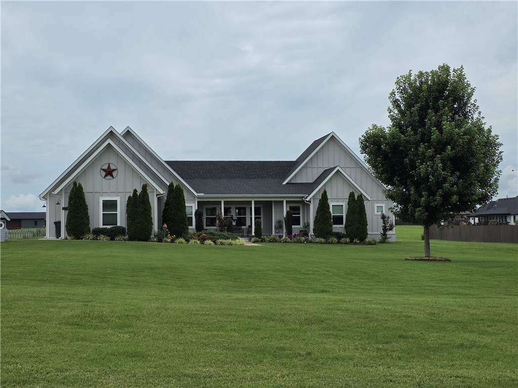 Set on 2.05 acres in Prairie Grove, this beautiful Craftsman-style home offers a thoughtful split floor plan with an open-concept heart. The primary suite and a bedroom/office sit privately on one side of the home, while three additional bedrooms are situated on the opposite side — two connected by a Jack-and-Jill bath, plus a third en-suite bedroom offering flexibility for guests or a mother-in-law setup — with the open kitchen and living area anchoring the space in between. The living area is warmed by a fireplace and filled with natural light, taking full advantage of sweeping pastoral views throughout. The chef's kitchen features butcher block and quartz countertops, a Thor six-burner double-oven convection propane range with griddle, and an eat-in breakfast nook. Additional upgrades include a hot water circulating system and a three-car garage with a 220V outlet. Pet-friendly home, odor-free. Out back, patio has been extended as well as buried propane line to off availability for tankless propane grill.