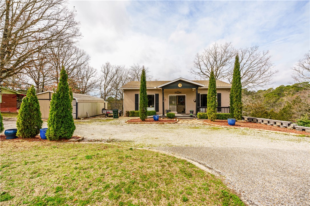 A rare 3,000+ sq. ft. live/work opportunity just outside Eureka Springs—where creativity, business, and home all come together. This versatile property is zoned for residential or commercial use. Previously home to an art gallery and glass-blowing studio, the layout easily supports retail, gallery, boutique, salon, office, Airbnb, or dual-level rental possibilities. The property includes a spacious gallery area at street level, multiple flexible living and work spaces, three bedrooms (another work space could be the 4th bedroom), an office, two large living areas, and an updated kitchen with granite countertops. A fireplace adds warmth and character, while central heat and air, double-pane windows, and architectural shingles provide comfort and efficiency. Covered porch, patio, and the deck areas offer inviting outdoor space, and a detached 2 car garage and separate storage building provides ample space needed. A unique opportunity to combine business, creativity, and comfortable living near Eureka Springs.