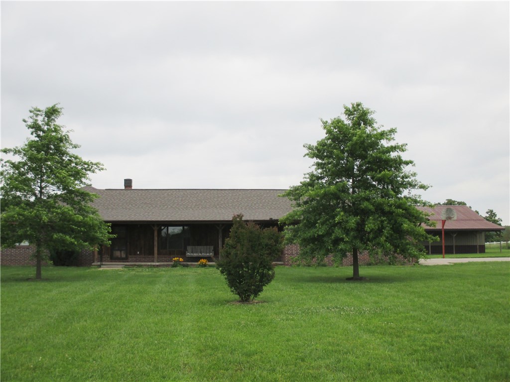 A beautiful ranch style brick home & metal shop on a peaceful setting at the end of the lane. The home features oak hardwood flooring in addition to carpet & title with custom oak cabinets in a large eat in-kitchen plus a formal dinning area. Relax in the open den with corner hearth & Harmon pellet stove! Lots of storage with four bedrooms & 2 3/4 baths & a large utilitity room w/sink & 3/4 bath! Metal shop, concrete floor, insulated, finished OSB walls & ceiling & electric! Big lawn & trees, must see!
