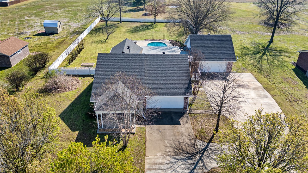 A 3,200+ sq. ft. executive residence blends refined comfort with quiet luxury, designed for both relaxation and entertaining.  PHENOMENAL and welcoming-accented with large windows that flood the interior with natural light. 2 wide, paved driveways lead to spacious four-car garages, ideal for multiple vehicles, storage, or even a workshop area. Formal living area leads to an elegant dining room, gourmet kitchen w/ premium appliances, spacious island. Sunroom/den is almost window to window and exudes a warmth that is undeniable. Massive bedrooms, spa-like bathrooms. Salt water pool plus pool house, 2 covered patios. Outdoor entertainment at its best. Separate bonus room with half bath is above the extra 2 car garage/shop.