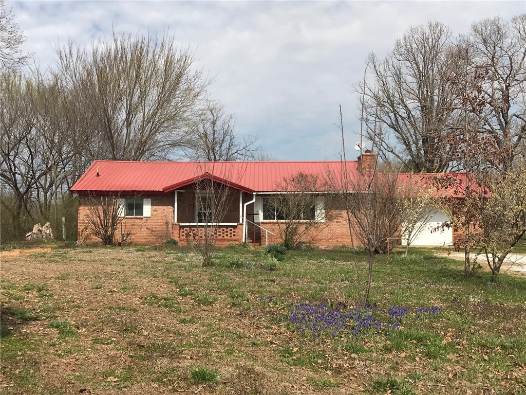 Farm house with lot's of room, 3 bedroom, 1 bath, 1 car garage.  This property has about 17 fruit trees, grapes  and beautiful flowers.  New  HVAC in 2015, water line from street to home 2018, new windows all except garage  2015,. There is a 200 ft. well in the garage that is not being used it has a pipe shaft but no equipment it was disconnected when rural water was connected.  This home is being sold AS-IS will not go R/D or FHA- Cash buyer- has water damage from a toilet leak property has had restoration and needs to be put back together.