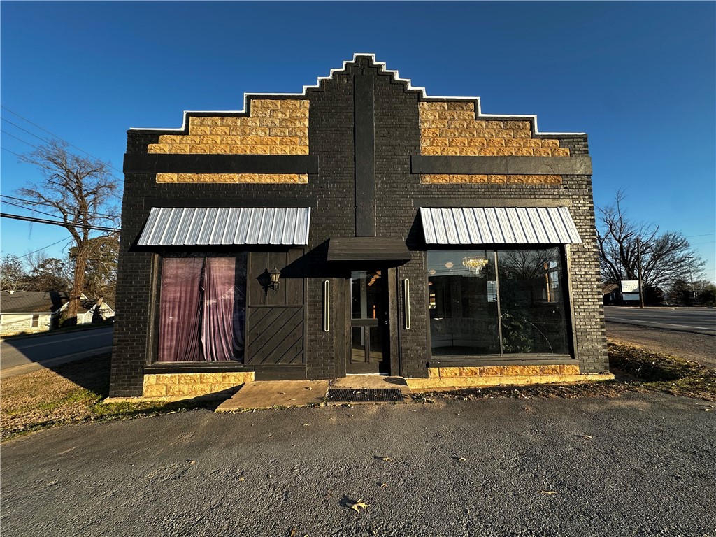 This pristine commercial building offers a rare opportunity to own a piece of Clarksville’s local heritage. Located on a high-visibility stretch of West Main Street, the property benefits from steady foot traffic and a prime position within one of Arkansas’s most charming small-town business corridors. Offering nearly 7,000 square feet, a new roof, and features a classic façade with large display windows. This building has timeless architectural details, making it ideal for retail, office, or specialty use. Surrounded by local shops, dining, and community anchors, this property is both a solid investment and a standout presence in Clarksville. Call for your private showing today!