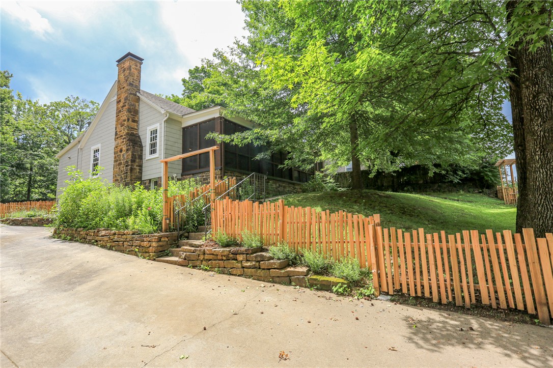 Discover this beautiful fully restored historic home nestled in the Historic District of Fayetteville. Located just a few blocks from Dickson Street, the Square, Walton Arts Center and the University of Arkansas, you'll love the friendly neighborhood vibe. The property features beautiful hardwood floors throughout with a fully updated gourmet kitchen. This charmer is full of character and warmth! Enjoy your morning coffee on the screened-in front porch overlooking the tree lined street. An additional garage/workshop area under the house makes for a great place for your temporary storage needs.