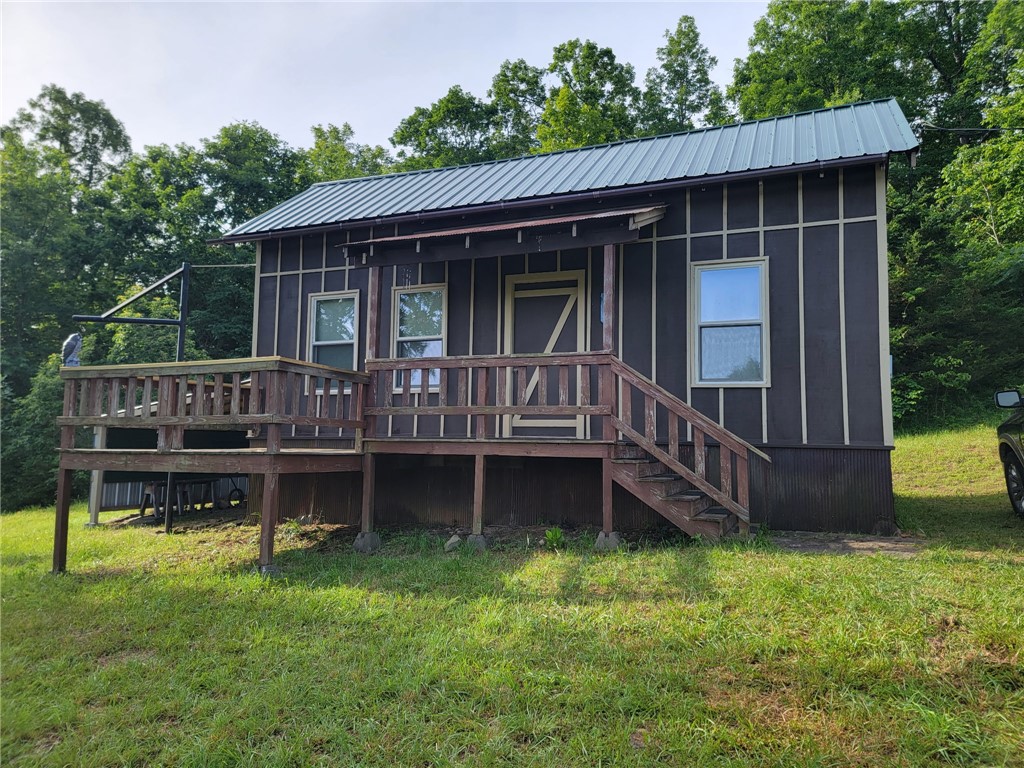 Secluded, Peaceful, Beautiful describes this 6.16 acres and Cabin. It has a 10x12 loft that makes for 2 Bedrooms and 1 bath. Great place for a weekend retreat or your home place, or airbnb, or hunting cabin. Lots of opportunity for growth. Close to the Buffalo River and the Ozark National Forest. Many great things to do ride 4 wheelers, horses, canoeing, kayaking, hiking, hunting, and fishing and many more. This nice cabin has public water and electric and septic tank ready to move in. Has a locked gate and security. Must make appointment for all showings. Call today before it is too late.