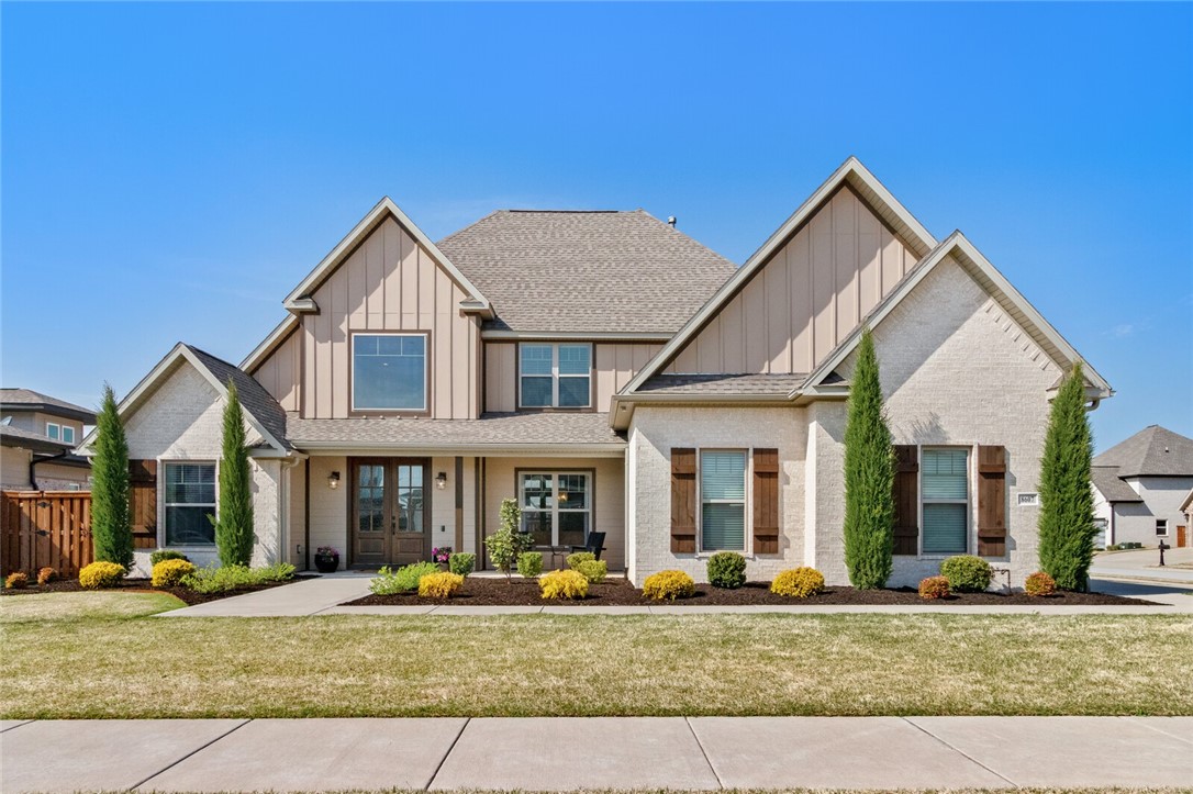 This stunning residence is set on a large corner lot in the sought-after gated Scissortail subdivision and features 2 bedrooms on the main level!  Noteworthy designer features include gorgeous wood floors, elevated beam ceilings, extraordinary millwork, oversized windows, solid wood French doors, and custom built-ins. This desirable floor plan offers an inviting entry hall, formal dining room, great room with custom built-ins and gas log fireplace, a main level owners suite, spacious utility room, and three secondary bedrooms along with a generous sized bonus room with a wet bar. The open, high end gourmet kitchen offers a large island, tons of cabinetry, gas cooktop with pot filler and eat in area with extended custom cabinetry.  This open floor plans boasts tons of natural light and a great room with a glass wall showcasing the outdoor entertaining areas featuring a covered patio with a wood burning fireplace and fabulous built-in grilling station.
