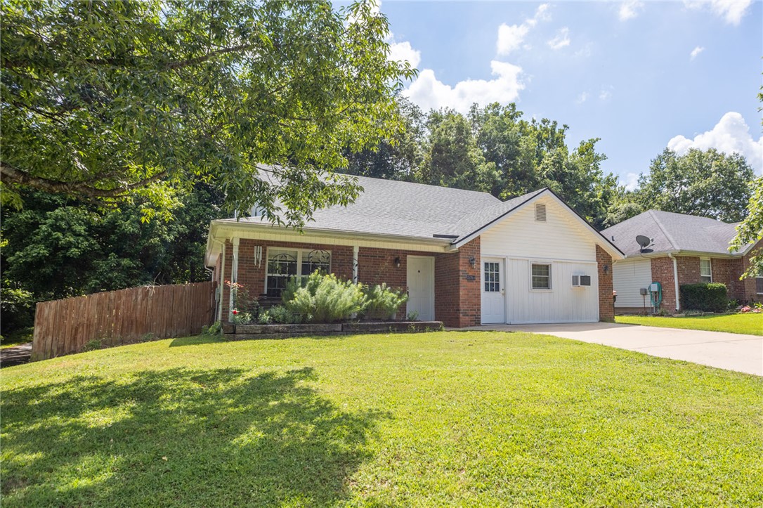 Are you city folk or are you the lake type? Maybe you can just be both. This nearly-lakefront home in the tightly-knit Blue Springs Village community is close to the water, visible from your front porch, five mins from the nearest public boat launch, and just 15 mins to downtown Springdale. The owners have lived here for almost 25 years, and for good reason. The house sits on a nice corner lot in a very low-traffic area with a peaceful, shaded back yard that is just swimming in privacy and best enjoyed from the large covered deck. Inside the home awaits your updates to make it that lake retreat you can't wait to come home to everyday. The garage was converted a few years back to add a needed extra downstairs bedroom, but it was done so that converting it back should be a breeze. Or heck, keep it as a large game room or second living room. With all these possibilities, plus the freshly painted interior, the only 1-year-old roof and a carpet allowance of $3000, you are well on your way to making this house your home.