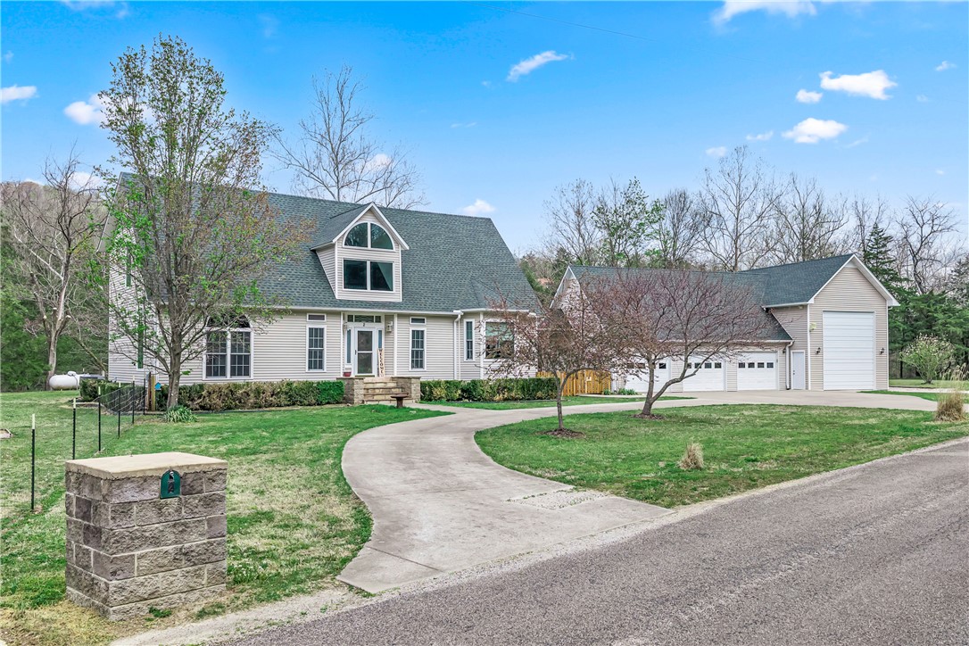 Tired of NWA traffic? Want to commute to Rogers and Bentonville but come home to a peaceful paradise? Welcome to Holiday Island — America's Best Kept Secret — and the word is getting out! This stunning, private 3-bed, 2.2-bath colonial sits on .82 acres with breathtaking Ozark Mountain views and unmatched peace and privacy. Minutes from the coveted Holiday Island Marina, enjoy free and easy boat access to Table Rock Lake — a legendary fisherman's paradise famous for world-class fishing. Perfect for water lovers! Inside, 2,305 sq ft features soaring ceilings up to 29 feet, granite counters, a jetted tub, and walk-in closets in every bedroom. Major updates include a 2023 roof, new AC (2025), triple-pane windows, and a whole-home generator. A massive RV garage, 3-car garage, and attic storage are unmatched. The included second lot is flat and buildable. Community pool, golf, tennis, and trails complete this rare gem.