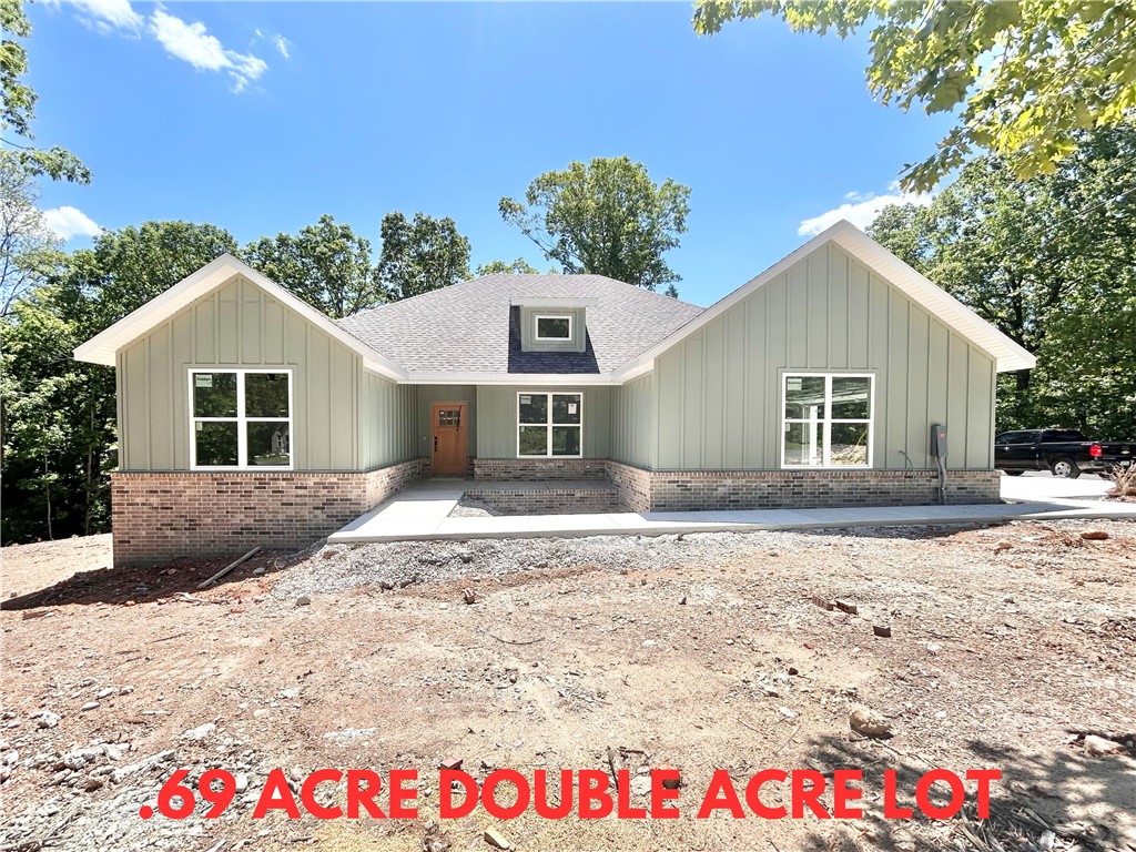Stunning new construction home on a .69 acre double wooded lot with flat backyard located right next to Branchwood Recreation Center and Trails! Also within close proximity to Highlands Golf Course, Lake Loch Lomond, and I-49! Step inside to discover a beautifully designed interior with 4 bedrooms, a split floor plan, & high-end modern finishes throughout. 2 car side load garage! The spacious living area showcases vaulted ceilings with elegant beams, creating an inviting atmosphere. The kitchen features sleek 3 cm quartz countertops, a gas range, custom cabinets, and stainless-steel appliances. Retreat to the luxurious primary bath, which boasts a huge walk-in closet, a large custom walk-in tile shower, and a soaking tub. 2 covered patios. As an added bonus, receive $3,500 towards buyer's closing costs when working with the builder’s preferred local lender! "Front exterior will be painted Sherwin-Williams Evergreen Fog"