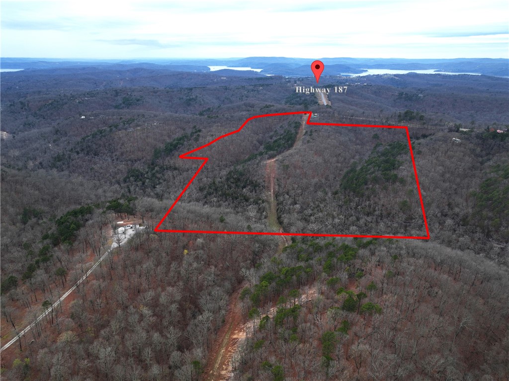 Discover the beauty of this stunning 61.3 +/- acre property, just minutes away from Beaver Lake and 15 minutes from Eureka Springs.  This prime location offers several ideal spots to build your dream home or homes. One of these prime locations already has a septic tank installed, perfectly sized for a 3-bedroom house.  This property has breathtaking cliffs and rocky boulders to lush hardwood forests with various hardwood trees. A creek meanders through the East end of the property, adding to its charm. On the property is an abundant of white-tailed deer and turkey. Conveniently located just 15 minutes from Eureka Springs. Whether you're seeking to escape or adventure for hunting, hiking, or exploring, this property has something for everyone. Don't miss your chance to make it yours! Owner will also subdivide and sell 20 acres see MLS Number: 1271119.
