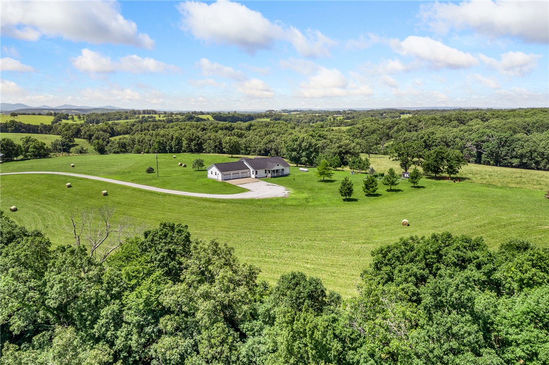 If you've been searching for a property that checks all the boxes, this may be the one you've been waiting for. Situated on 13.68 acres of beautiful, mostly hay pasture just minutes from Bergman, this meticulously maintained 3-bedroom, 2-bath home offers space, privacy, and peace of mind that are getting harder to find. With 2,780 sq. ft., there's plenty of room to enjoy country living. The attached sunroom with its own mini-split is perfect for morning coffee or year-round relaxation. A whole-home generator adds comfort and security in every season. Tucked down a short dirt road, you get privacy without sacrificing convenience.
Whether you're looking for a hobby farm, horses, or room to breathe, this property delivers a rare lifestyle opportunity. Don't miss your chance to make it yours.