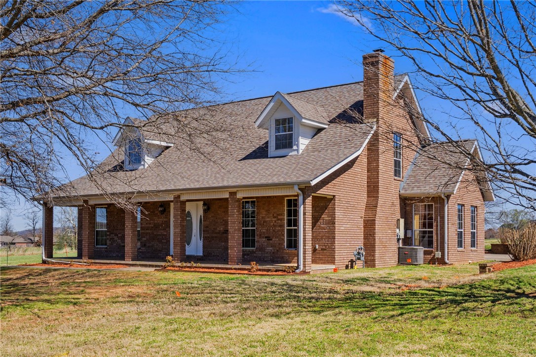 Rare find! Custom home on 3 acres in Fayetteville + 1280 sf shop. This traditional country home features 3 bedrooms with the primary suite on the main level, bamboo flooring, a wood-burning fireplace, eat-in kitchen, and a bright sunroom perfect for an office or sitting area. Upstairs offers a large bonus room with barn-style ceiling and private deck access, providing potential for a fourth bedroom or flex space. New carpet installed March 2026. New roof 2021. Shop building is insulated with electric (110 & 220) and rough-in plumbing. Enjoy a peaceful setting with mature trees and open land from your covered front porch, sunken patio or deck. Come see this incredibly maintained 1 owner home. Just ~4 miles to the University of Arkansas, Dickson Street, and Interstate 49. Up to $6,000 closing costs paid with preferred lender. Carport conveys.