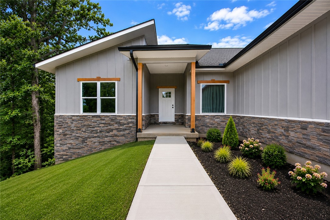 If you’ve been searching for something beyond the average new construction home in Bella Vista, this is it. Perfectly positioned on a corner lot directly on Tunnel Vision Trail with nearby trailhead access just moments away, this 3-bedroom, 2-bath home with dedicated office was designed for those who value both elevated living and outdoor adventure. Offering 1,929 sq ft of thoughtfully curated space, the home blends modern mountain-inspired design with quality craftsmanship and attention to detail rarely found in typical new construction. The striking exterior, oversized 3-car garage, and wooded surroundings create an immediate sense of privacy and character, while the location places world-class biking and walking trails literally in your backyard. Whether you're an avid cyclist, nature lover, or simply looking for a home with more style, function, and personality, 2 Grier Lane delivers a lifestyle that stands apart. See List of Upgrades for additional features and enhancements throughout the home.