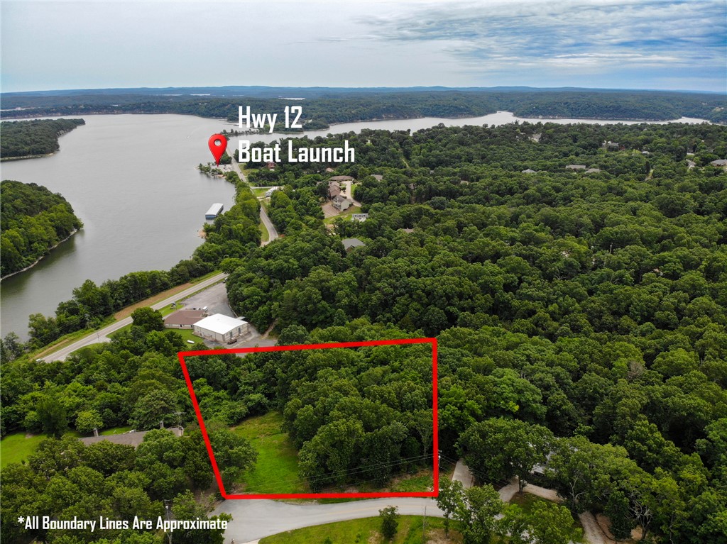 Don't miss your opportunity to build on one of the last bluff views overlooking Beaver Lake near the bridge !  Just 10 minutes from downtown Rogers and 3 minutes to Hwy. 12 boat ramp and beach, this 2.21 acres in a secluded cul-de-sac needs a new owner to enjoy the view. A small part of the north end of the lot has been cleared to demonstrate the potential of this property. Property goes all of the way down so more tree trimming would create an extraordinary perspective.  Electricity and water at street, septic would be required. Property is directly across from 8263 Anchor Dr.   It is advisable to access property from Beaver Shores Drive or Linville Road and not directly from Hwy. 12 like GPS suggests.