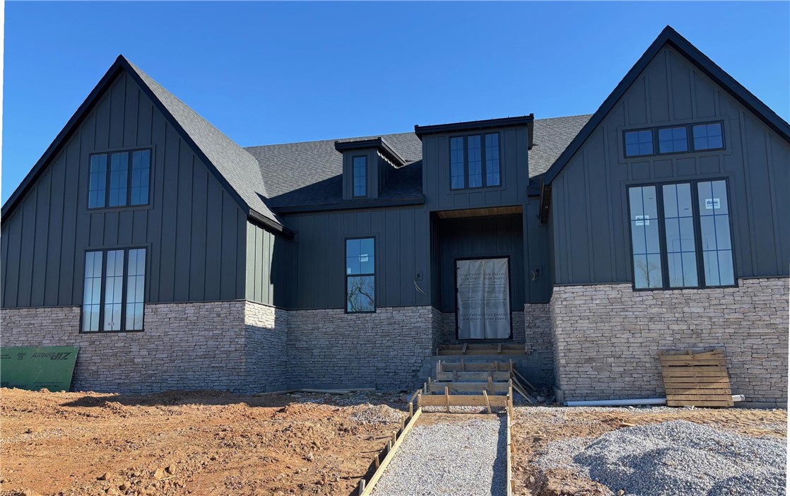 Built by the 2024 Parade of Homes Gold Medal winner! Feast your eyes on our one-story Carson floor plan.  This jaw dropping home is filled with luxurious finishes & sits on a large corner lot within walking distance to the community pavilion & green space. This home features a premium quartz waterfall kitchen island, oversized windows, & sliding glass doors, creating an outstanding indoor/outdoor entertaining space. The elegant main suite includes a separate tub & shower with floor-to-ceiling tile, dual shower heads, his/hers sinks on opposite sides of the bathroom as well as a separate office space. The home offers a bonus room that could double as a 5th bedroom, & a three-car garage. You'll find high-quality finishes throughout, such as quartz countertops, GE Cafe appliances, custom cabinetry, a "hidden" pantry, & soft-close cabinets with under-cabinet lighting.  Located just 2 miles from the Bella Vista by-pass, 5 miles from Coler Mtn, 7 miles from downtown Bentonville, & 8 miles from Wal Mart Home Offices!