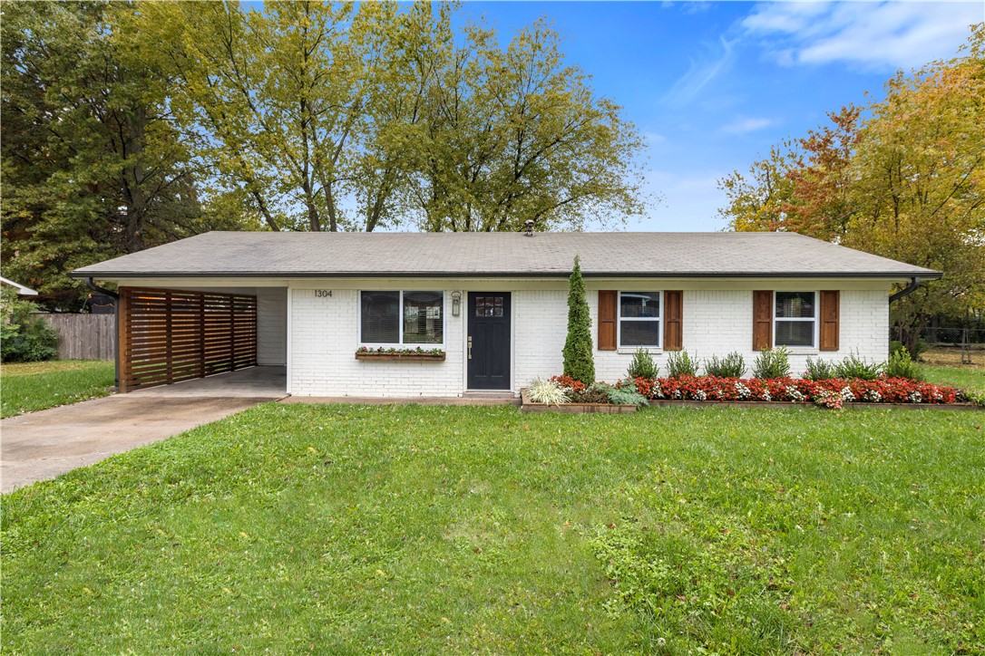 Amazing home in an awesome location! Updates include new windows, interior & exterior paint, stainless steel appliances, painted cabinets with new doors, new flooring in living room & bedrooms, shutters, gutters, & deck in back yard. Shed, playhouse and fire pit in spacious fenced in backyard. Great location! House is between current WM home office, new WM home office location, & downtown Bentonville.