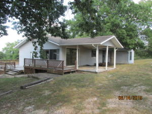 Home, 28x40 Shop, 5 acres, large living room, nice kitchen and dine, deck & covered patio. Some repairs and maintenance are needed, property is being sold in As Is condition. A portion of this home was a mobile home, repairs include new floor coverings, interior paint, PVC line near water heater. Actual age is unknown, sq ftg, lot size, acreage, etc, are from public record, Buyer should verify.