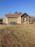 INVESTORS SPECIAL Repair and reap the rewards. Small fixer upper home located on 2 partially cleared acres just inside Denning with a large 24x32 shop with double roll doors. Shop has its own electric meter as well as its own address. This property features mature pine trees and an in ground storm cellar. New siding on 3/4 of the home.