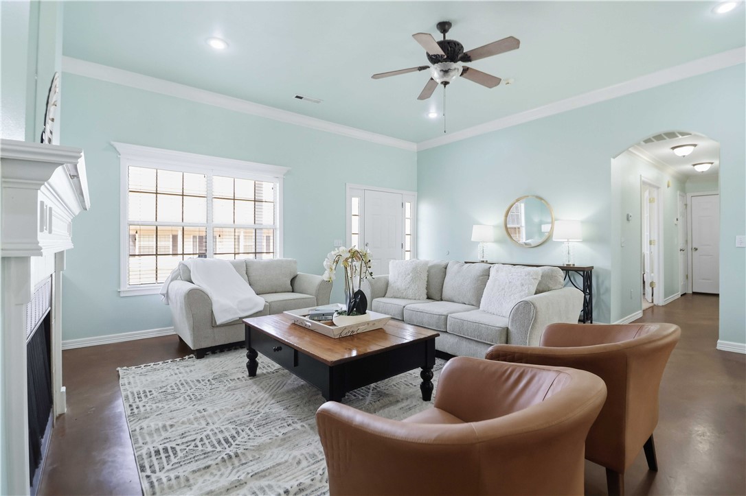 Dang cute doesn’t even begin to cover it! This thoughtfully designed 1,689 sq. ft. home feels peaceful, welcoming, and lives much larger than its footprint. Featuring three bedrooms plus a versatile bonus room with French doors and a closet, this flexible space can easily function as a fourth bedroom, home office, second living area, or creative studio. (I’ve even sold this exact floor plan where the bonus room was perfectly used for in-home daycare services!)

The open-concept living area flows seamlessly into the kitchen, showcasing built-ins and a cozy wood-burning fireplace that anchors the space. Stained concrete floors throughout the main living areas offer both style and easy maintenance, while brand-new carpet has recently been installed in all bedrooms for added comfort. Every square foot is utilized beautifully, creating a home that feels spacious, functional, and just plain happy.