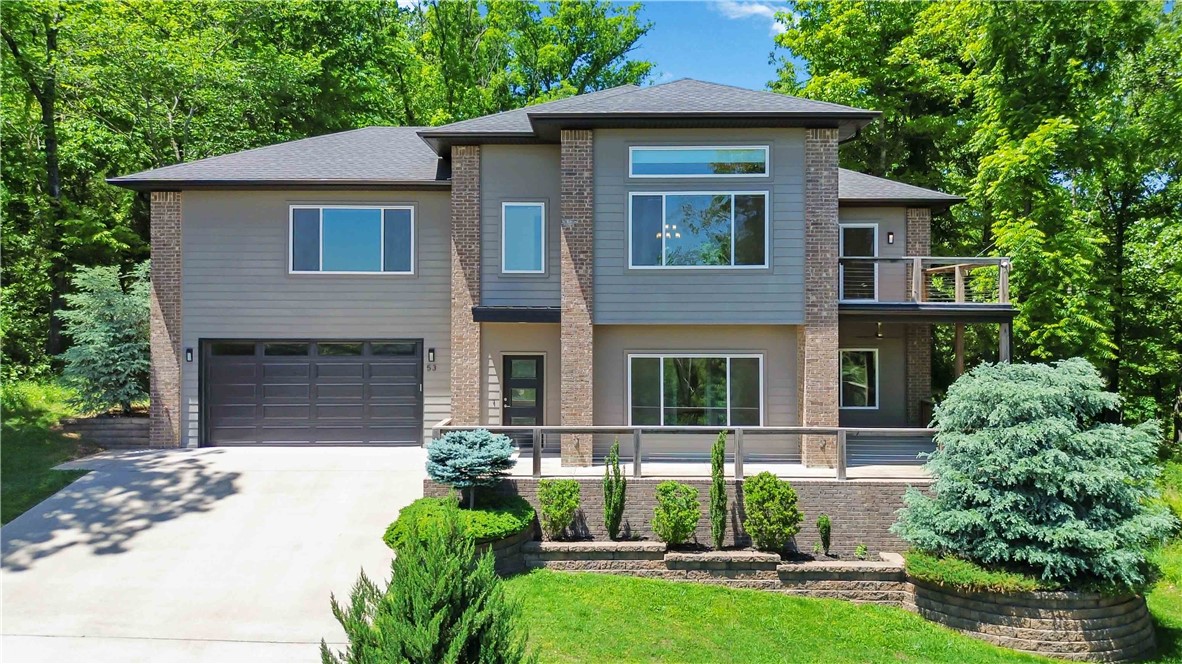 This stunning EAST Facing, LAKE-VIEW home offers a unique and flexible layout just 4 minutes from Lake Windsor and 7 minutes from the new Ozark Trail lift. The main level features a formal living room, 2 guest bedrooms, full bath, new carpet with elite foam padding. Upstairs features the kitchen, dining area, primary suite, and a stunning family room with, propane fireplace, custom railroad wood accent wall, ambient lighting, and year-round lake views. The top window in the upstairs family room features a motorized shade.The kitchen has a waterfall granite island with railroad wood accents, soft-close cabinets, slide-out pantry drawers and under-sink filtration system. Laundry room on both levels.Primary bath includes a whirlpool tub, tiled shower, and double vanity. Additional features: dual-zone HVAC controls, new AC (2023), screened-in porch (2020), front and back decks,Tesla charger, whole-house surge protector, gutter guards, smart recessed lighting, built-in garage storage.
