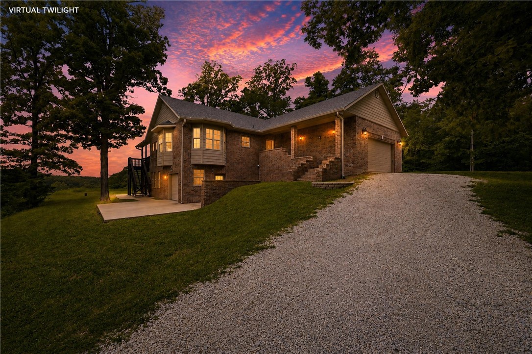 Acreage, views, Bentonville Schools, and rare flexibility make this Bella Vista property one you don’t see every day. Sitting on 3.17 total acres and not part of the POA, this home offers a rare Bella Vista setting without the typical POA restrictions. Inside, the craftsmanship stands out with hickory cabinets, white pine ceilings and baseboards, detailed woodwork, and two wood-burning fireplaces. The walkout basement adds even more versatility with a bedroom, full bath, large second living area, epoxy-coated concrete floors, extra storage, and a completely separate lower-level garage/workshop area. With its own garage door access and electrical hookups, this space is ideal for bikes, tools, EV charging, or hobby projects. Recent updates include a 2024 roof, 2025 double oven and gas cooktop, and well-water filtration system. The subdivided parcel has its own address and electric meter, creating future possibilities — buyer to verify permitted uses.  See attached features sheet for additional details.