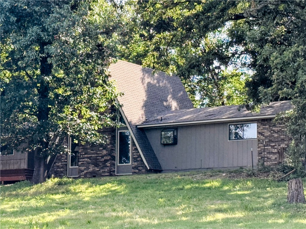 Unique A-frame home situated on 1.65 acres surrounded by mature trees and a large front yard. This 3-bedroom, 2-bath home features vaulted ceilings, natural light, and a beautiful natural setting. The updated kitchen offers granite countertops and newer cabinetry, while the spacious bedrooms provide plenty of room to spread out. A bonus room just off the entry makes an ideal home office, hobby room, or flex space. 
Enjoy the privacy of the backyard patio overlooking a wooded setting beyond the stone retaining wall. Stay cozy during the winter months with the wood-burning stove. Major updates include a roof that's only a few years old and an HVAC system approximately 4-5 years old.

Conveniently located near Ozark Adventist Academy in Gentry, within the Siloam Springs School District, and just minutes from City Lake with fishing, hiking, and mountain biking trails. With a little TLC, this property could truly shine!