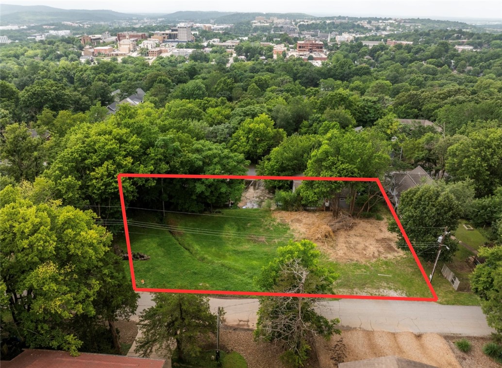 Located at the top of East Spring Street, on Mt Sequoyah in Fayetteville, this property is primed for redevelopment. Currently zoned RSF-18, this half acre, more or less of property needs a new vision to take advantage of the limited availability of lots in this area. Mt Sequoyah holds the consistency of one of the most desirable areas in Fayetteville, offering views, and walkability to downtown Fayetteville, but still holding the neighborhood feel. Three rental properties are onsite. Total monthly income is $1,750. Existing water and sewer taps onsite.