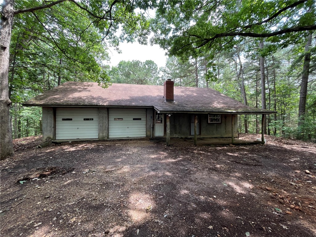 Great opportunity to buy a Concrete Home with a basement and almost 16 acres. Upper level has 576 heated area of living quarters along with a two car garage. Lower level is unfished full basement with a two car garage. Lower level could be made into living quarters as well. Main level has one bedroom , one bathroom, living area and a kitchen. Home has a good water well. House is easy to heat and stays cool in the summer. 8 inch concrete walls. Lots of opportunity here. Garage area could be converted to living area which would be an additional 850 feet. Lots of tall beautiful Pine Trees around the House and on the property.