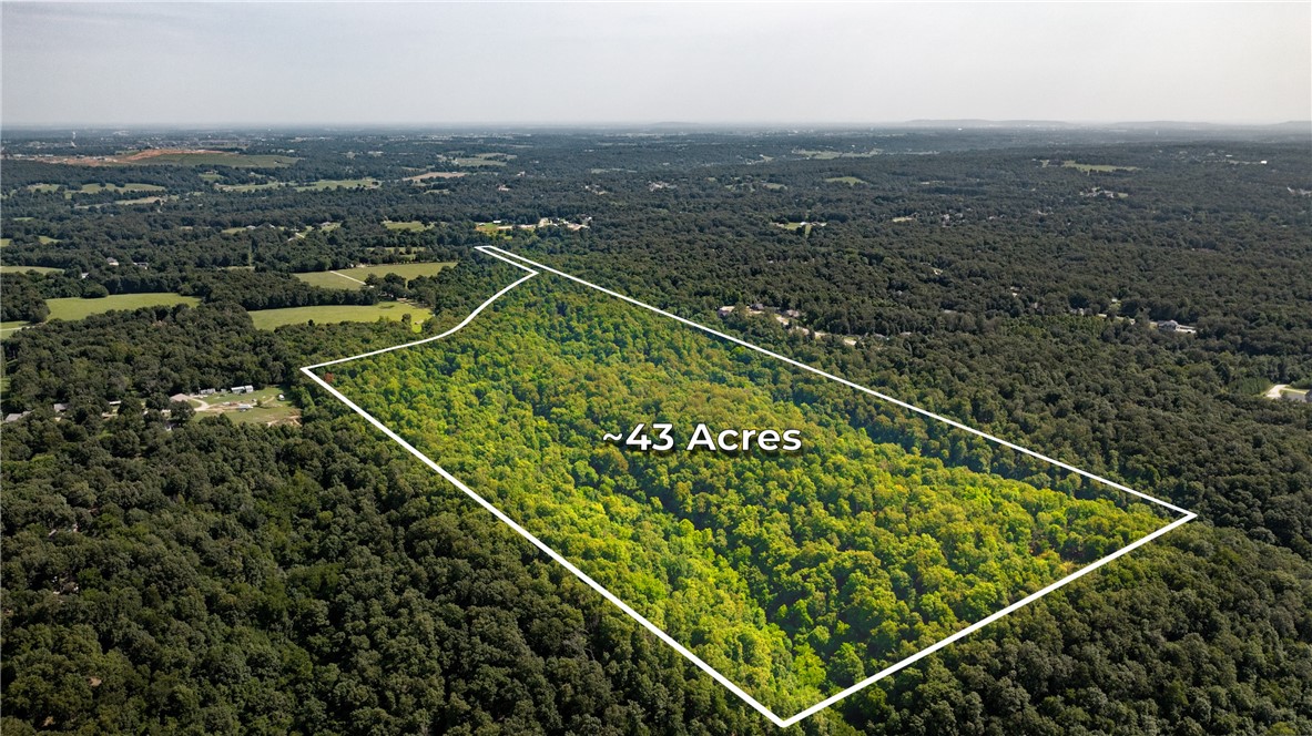 Approximately 42.5 wooded, private acres available near Tontitown and Fayetteville, within the Farmington School District. A portion will be surveyed from an adjacent parcel to provide access. This versatile property is ideal for a private estate or could be subdivided into multiple smaller lots—buyer’s choice. Water, electric, and natural gas are available in the neighboring development to the east. Enjoy peaceful seclusion with the convenience of nearby recreation, shopping, and business hubs. There is also a lot of deer and wildlife on the property. A rare opportunity to own acreage with development potential in a prime location!